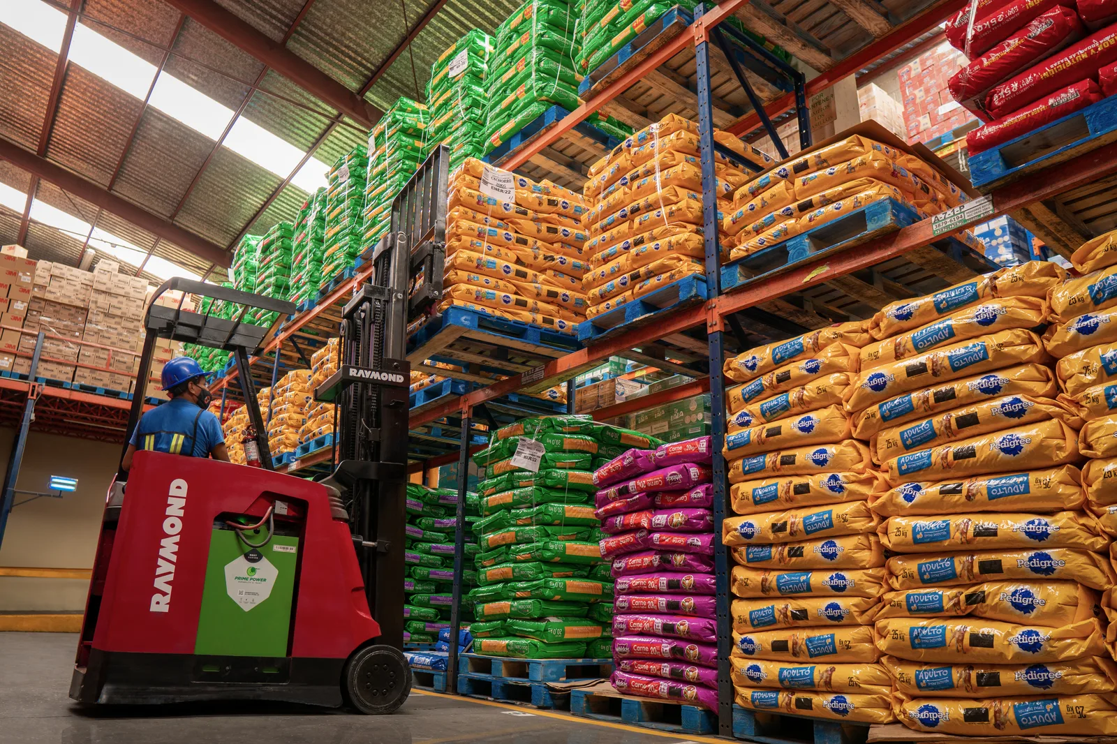 Montacargas operando entre racks de abarrotes en el almacén de CEVISUR